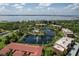 Stunning aerial view of the community showcasing lush landscaping, a serene lake, and well-maintained buildings at 23465 Harborview Rd # 842, Port Charlotte, FL 33980