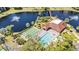 Beautiful aerial view of community pool, clubhouse, bocce ball court and pond with fountain at 23465 Harborview Rd # 842, Port Charlotte, FL 33980
