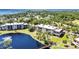 Aerial shot showing the community buildings near a lake with a bridge and beautifully landscaped grounds at 23465 Harborview Rd # 842, Port Charlotte, FL 33980