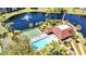 Beautiful aerial view of community pool, clubhouse, bocce ball court and pond with fountain at 23465 Harborview Rd # 842, Port Charlotte, FL 33980