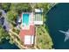 Aerial view showcasing the pool, hot tub, shuffleboard, and a beautiful lake with fountain views at 23465 Harborview Rd # 842, Port Charlotte, FL 33980