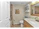 Well-lit bathroom with a vanity, neutral tile, and standard bath and shower at 23465 Harborview Rd # 842, Port Charlotte, FL 33980