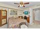 Cheerful bedroom with a colorful bedspread, ceiling fan, and built-in desk at 23465 Harborview Rd # 842, Port Charlotte, FL 33980
