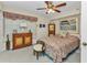 Inviting bedroom with vibrant bedding, a ceiling fan, and decorative furnishings at 23465 Harborview Rd # 842, Port Charlotte, FL 33980