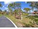 Outdoor wooded swing with lush green landscaping at 23465 Harborview Rd # 842, Port Charlotte, FL 33980