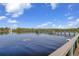 Scenic view from the wooden community dock surrounded by water and lush greenery on a bright, sunny day at 23465 Harborview Rd # 842, Port Charlotte, FL 33980