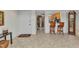Spacious foyer with tile flooring, a view into the kitchen, and a nearby grandfather clock at 23465 Harborview Rd # 842, Port Charlotte, FL 33980