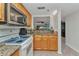 Compact kitchen design with granite counters and an open view into the living room at 23465 Harborview Rd # 842, Port Charlotte, FL 33980