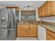 Efficient kitchen with stainless steel refrigerator, granite countertops, and ample cabinetry at 23465 Harborview Rd # 842, Port Charlotte, FL 33980