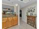 Bright kitchen view featuring wood cabinets, granite countertops, and a decorative wine rack at 23465 Harborview Rd # 842, Port Charlotte, FL 33980