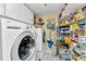 Functional laundry room with washer, dryer, shelving, and ample storage space for household supplies at 23465 Harborview Rd # 842, Port Charlotte, FL 33980