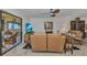 Comfortable living room showing leather furniture, a flat-screen TV, and a view to the balcony at 23465 Harborview Rd # 842, Port Charlotte, FL 33980
