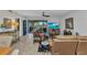 Cozy living room with comfortable leather furniture and a sliding glass door to the outside balcony at 23465 Harborview Rd # 842, Port Charlotte, FL 33980