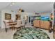 Open-concept living and dining area with contemporary decor and a tropical view through the sliding doors at 23465 Harborview Rd # 842, Port Charlotte, FL 33980