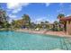 Serene pool scene with lounge chairs, umbrellas, and a barbecue area, perfect for outdoor gatherings at 23465 Harborview Rd # 842, Port Charlotte, FL 33980