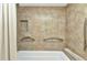 Tiled bathtub shower with a built-in niche and sleek chrome fixtures at 23465 Harborview Rd # 842, Port Charlotte, FL 33980