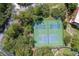 Aerial view of tennis courts surrounded by lush greenery, providing an active recreational space at 23465 Harborview Rd # 842, Port Charlotte, FL 33980