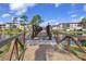 A picturesque bridge stretches across a serene lake, connecting to well-maintained buildings under a clear sky at 23465 Harborview Rd # 842, Port Charlotte, FL 33980