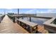 A wooden dock bench offers stunning waterfront views, perfect for relaxing by the sea at 23465 Harborview Rd # 842, Port Charlotte, FL 33980