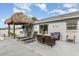 Spacious backyard with a pool, tiki bar, lounge area, and well-kept landscaping at 242 Seminole Nw Blvd, Port Charlotte, FL 33952