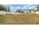 Expansive backyard view, featuring a pool, tiki bar, and outdoor living area at 242 Seminole Nw Blvd, Port Charlotte, FL 33952