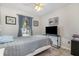 Comfortable bedroom with a ceiling fan, window with natural light and beach-themed decorations at 242 Seminole Nw Blvd, Port Charlotte, FL 33952
