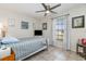 Cozy bedroom features tile flooring, a ceiling fan, natural light and neutral colors at 242 Seminole Nw Blvd, Port Charlotte, FL 33952