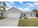 Inviting single Gathering home featuring a lush front lawn and attached two-car garage at 242 Seminole Nw Blvd, Port Charlotte, FL 33952