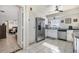 Kitchen featuring stainless steel appliances and convenient access to the bedroom and other living spaces at 242 Seminole Nw Blvd, Port Charlotte, FL 33952