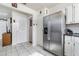 Bright kitchen with a stainless steel refrigerator and convenient access to other living areas at 242 Seminole Nw Blvd, Port Charlotte, FL 33952