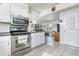 Efficient kitchen featuring stainless steel appliances, tile floors, and ample cabinet space at 242 Seminole Nw Blvd, Port Charlotte, FL 33952