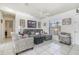 Comfortable living room with tile flooring, a ceiling fan, and natural light from a window at 242 Seminole Nw Blvd, Port Charlotte, FL 33952