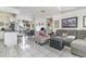 Open-concept layout with tile floors connecting living room, kitchen, and dining area creates a unified space at 242 Seminole Nw Blvd, Port Charlotte, FL 33952