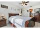Cozy main bedroom with ceiling fan, wood furniture, and easy access to en-suite bathroom at 242 Seminole Nw Blvd, Port Charlotte, FL 33952