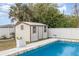 Poolside storage shed in fenced backyard with beautiful pool and stone deck at 242 Seminole Nw Blvd, Port Charlotte, FL 33952