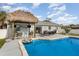 Backyard oasis featuring a pool, tiki bar, and outdoor seating, ideal for entertaining at 242 Seminole Nw Blvd, Port Charlotte, FL 33952