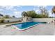 Backyard pool and shed surrounded by a white fence and well-manicured lawn, offering a private outdoor retreat at 242 Seminole Nw Blvd, Port Charlotte, FL 33952