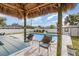 Outdoor seating with a tiki bar near a large pool with outdoor space at 242 Seminole Nw Blvd, Port Charlotte, FL 33952