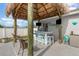 Outdoor tiki bar with seating and bar, great for backyard entertaining at 242 Seminole Nw Blvd, Port Charlotte, FL 33952