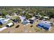 An aerial view of a home with screened-in pool, solar panels, a large yard and neighborhood at 3249 Cedarbrook Dr, Punta Gorda, FL 33982