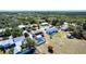 Aerial view of a property with a screened pool, spacious yard, and mature trees at 3249 Cedarbrook Dr, Punta Gorda, FL 33982