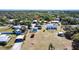 Aerial view of a home with a screened-in pool and spacious backyard near lush trees and waterways at 3249 Cedarbrook Dr, Punta Gorda, FL 33982