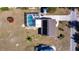 Aerial view of a home with a screened-in pool, patio furniture, and a tidy backyard at 3249 Cedarbrook Dr, Punta Gorda, FL 33982