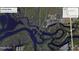 Aerial view of the property surrounded by a winding river and lush greenery at 3249 Cedarbrook Dr, Punta Gorda, FL 33982