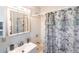 Bright bathroom featuring vanity, mirror, and bathtub with shower at 3249 Cedarbrook Dr, Punta Gorda, FL 33982