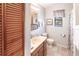 Well-lit bathroom featuring vanity, toilet, towel rack and window at 3249 Cedarbrook Dr, Punta Gorda, FL 33982
