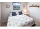 Bedroom with a patterned comforter, window, and a nightstand at 3249 Cedarbrook Dr, Punta Gorda, FL 33982