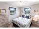 Bedroom has carpet, two windows, nightstand and dresser at 3249 Cedarbrook Dr, Punta Gorda, FL 33982