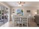 Dining room with seating for four, stylish decor, and sliding glass doors to outdoor patio at 3249 Cedarbrook Dr, Punta Gorda, FL 33982