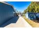 Home exterior with paved path leading to the screened porch and a storage shed at 3249 Cedarbrook Dr, Punta Gorda, FL 33982